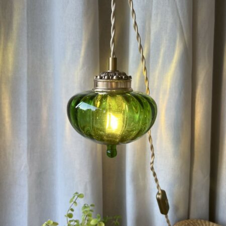 Baladeuse "toupie" en verre vert